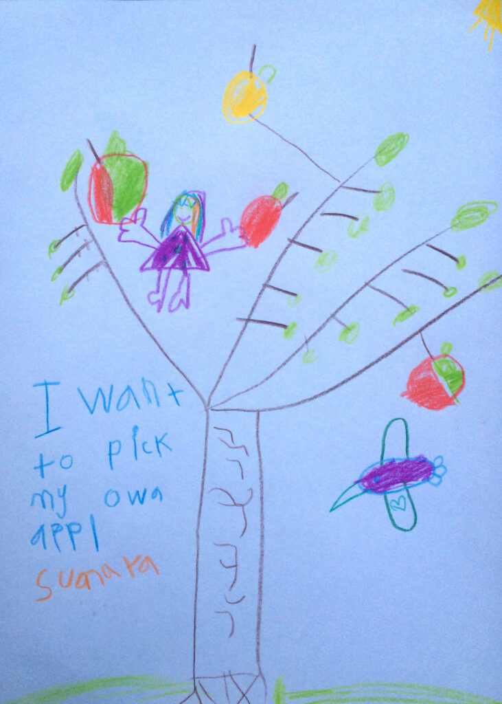 A child's drawing of an apple tree, with the text "I want to pick my own appl"
